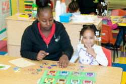 child doing an activity with her teacher